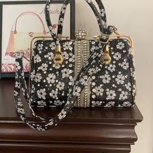 A black and white bag with gold trim.